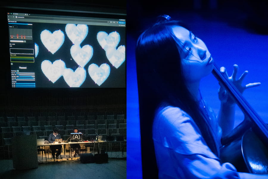 Screen with digital hearts projected onto alongside a woman playing a musical instrument in blue light.