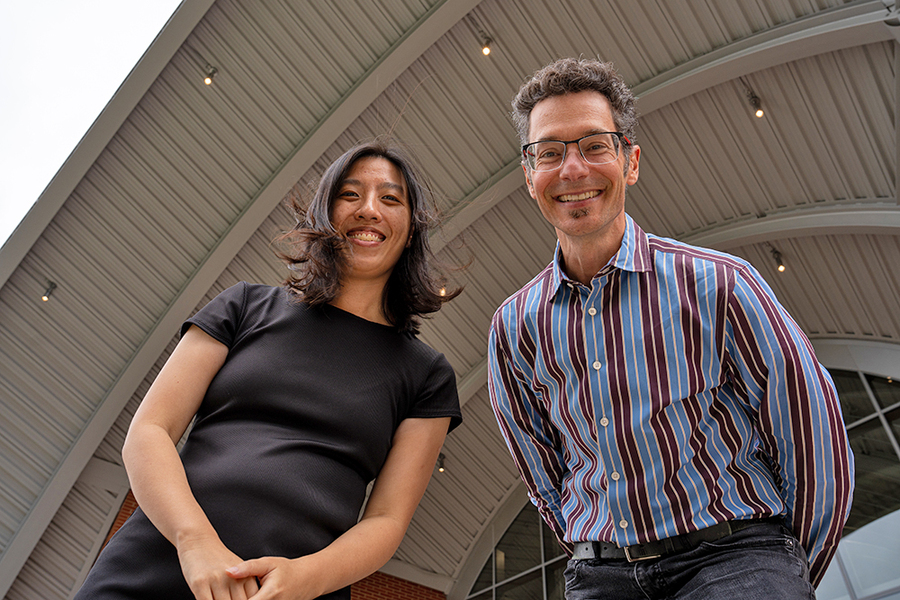 Anna Huang and Eran Egozy from below in front of the Edward and Joyce Linde Music Building at MIT.