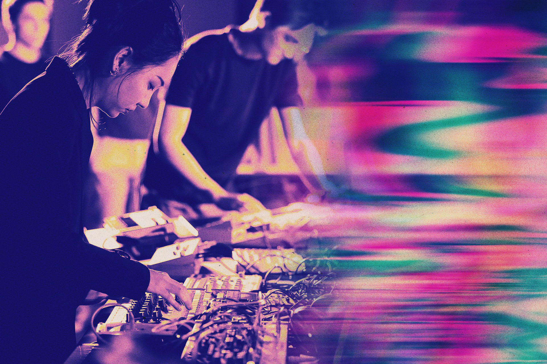 Students interacting with music technology equipment.