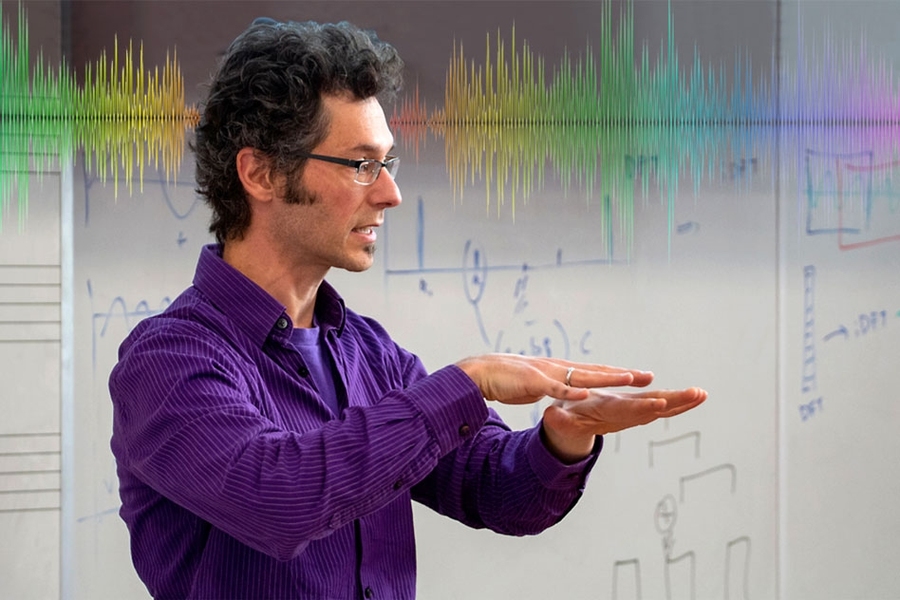 Faculty member in animated pose during class.