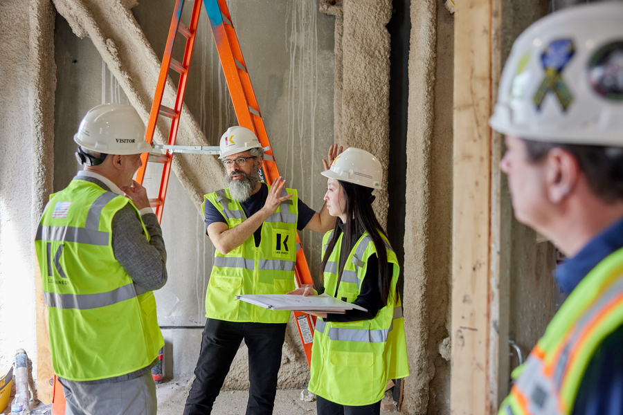 People in hard hats in a construction site.